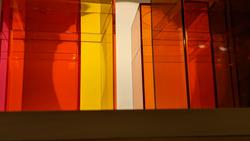 colored plastic pencil holders in from of a sphere light